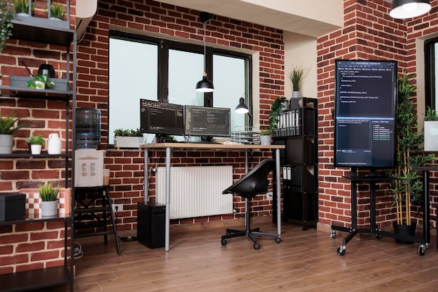 Interior of cyber security office center with neural networks\
and machine learning computers. empty office with nobody in it\
containing multiple displays showing system programming\
language.