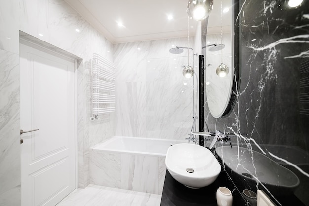 Interior design of a bathroom with light and dark tiles in a new house