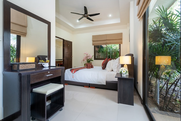 Interior design of house, home, condo and villa feature double
bed, red bed runner, and dressing table in bedroom