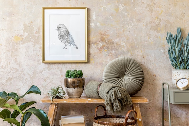 Photo interior design of living room with wooden bench. plants, cacti, pillow, plaid, rattan basket, gold poster frame, books and elegant presonal accessories in modern home decor.