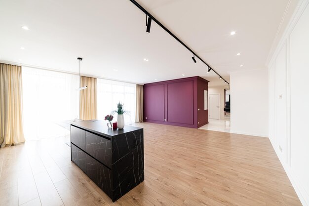 Interior design of a new kitchen in a house with large windows and furniture