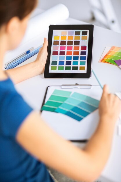 Photo interior design, renovation and technology concept - woman working with color samples for selection