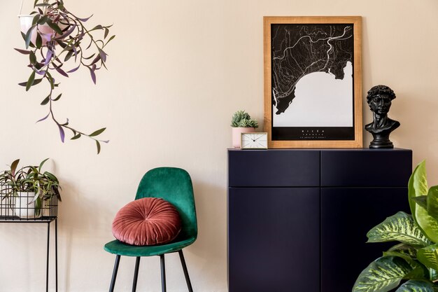 Interior design of sitting room with stylish velur chair, gold clock, plants, commode and elegant personal accessoreis. Brown wooden mock up poster map on the beige wall. Home decor. Template.