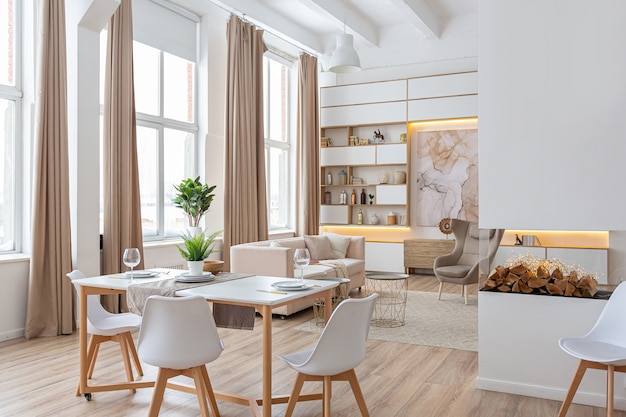 Interior design spacious bright apartment in Scandinavian style and warm pastel white and beige colors. trendy furniture in the living area