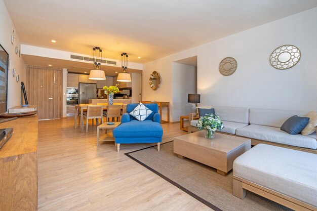 Photo interior design in villa, house, home, condo and apartment feature living room with television, middle table, cushion and open space kitchen and dining room