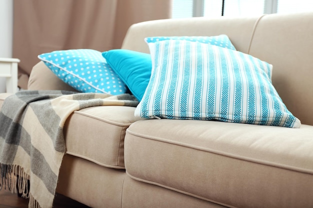 Photo interior design with pillows on sofa closeup