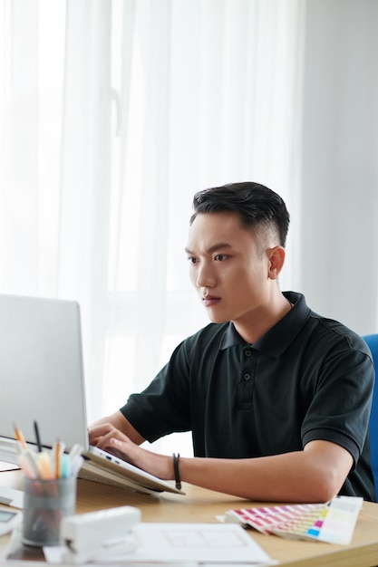 Interior Designer Working on Laptop