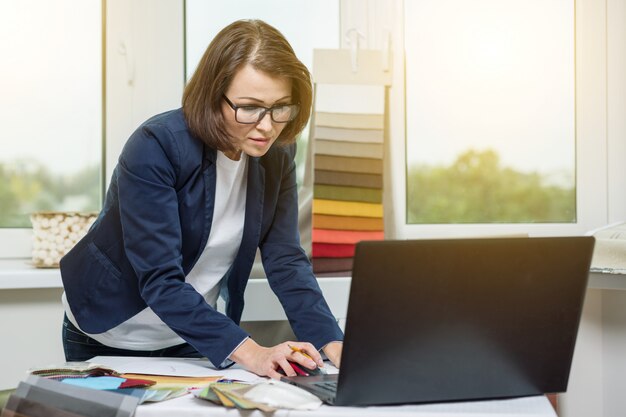 The interior designer, at the workplace in the office