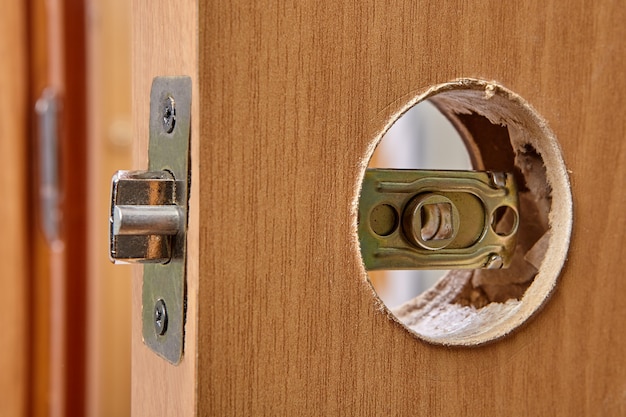 Interior door lock latch at stage of doorknob installation.