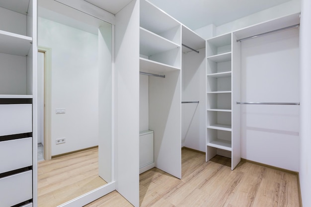 The interior of an empty dressing room is a lot of white shelves