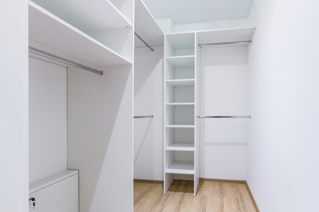 The interior of an empty dressing room is a lot of white shelves