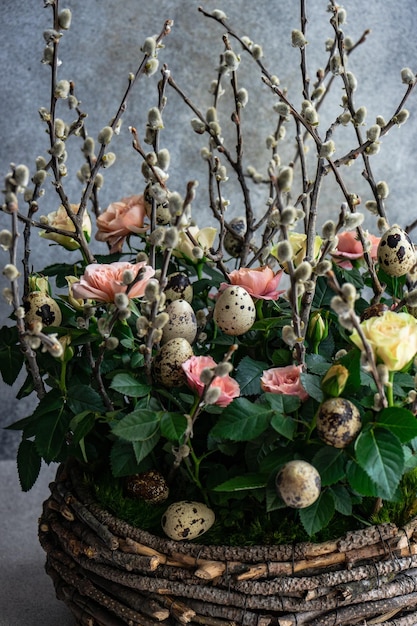 Interior florist composition with roses and willow