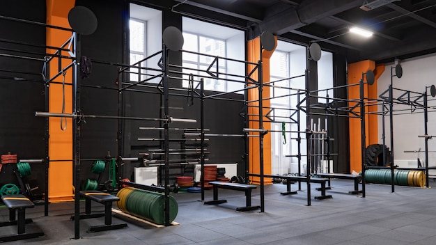 Interior of gym for fitness training with horizontal bar and barbells