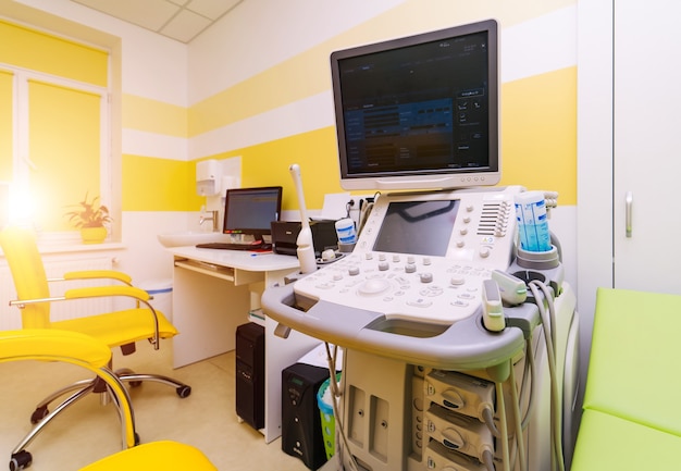 Interior of hospital room with ultrasound machine and bed