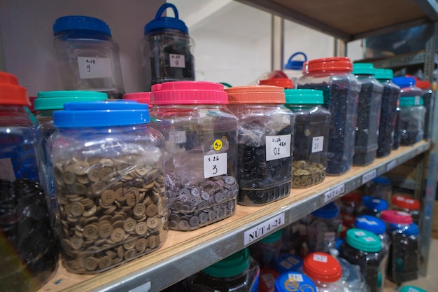 Interior of a industrial trim warehouse with many shelves with colorful button