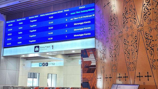 Interior of an international airport terminal with flight information board in indonesia