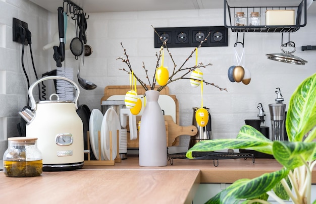 Interior of kitchen and details of decor of utensils with Easter decoration of colorful eggs in a loft style Festive interior of a country house