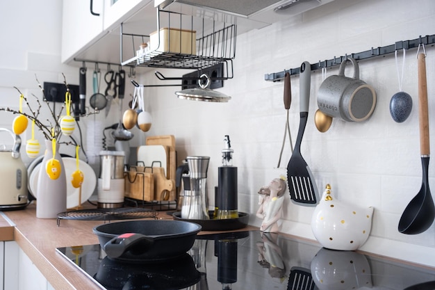 Interior of kitchen and details of decor of utensils with Easter decoration of colorful eggs in a loft style Festive interior of a country house