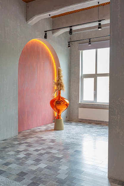 Interior of a large apartment in oriental mixed with loft style with arches led lighting and bright orange elements