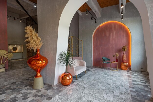 Interior of a large apartment in oriental mixed with loft style with arches led lighting and bright orange elements