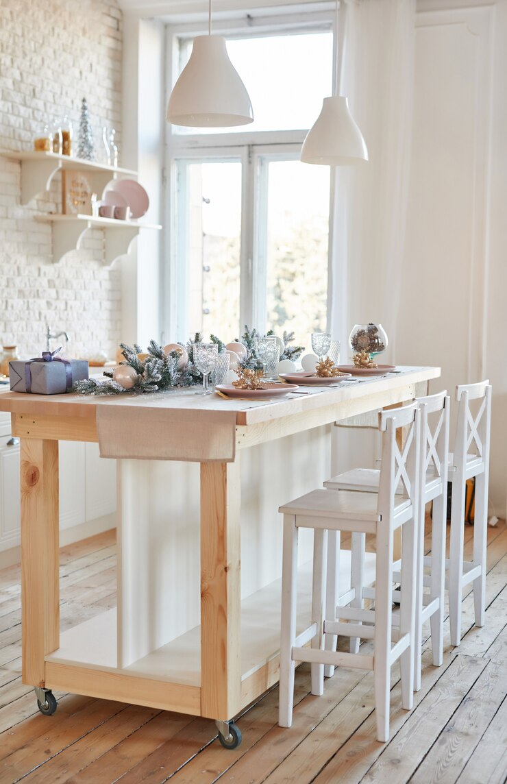Interior light kitchen with christmas decor and tree. White kitchen in classic style. Christmas in the kitchen. Bright kitchen in white shades with Christmas.