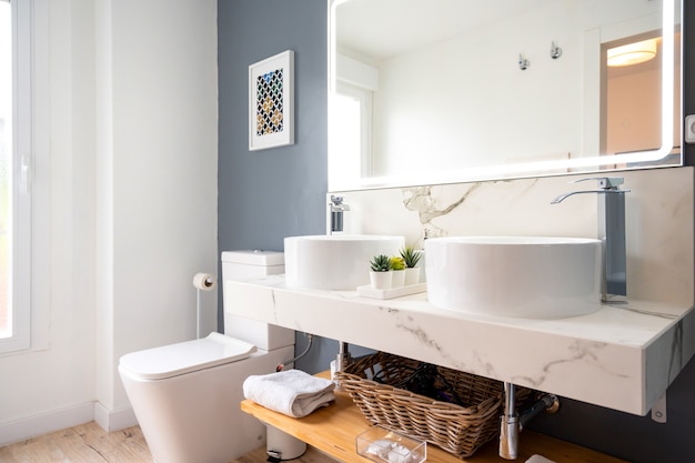 Photo interior of light modern bathroom with a mirror with light