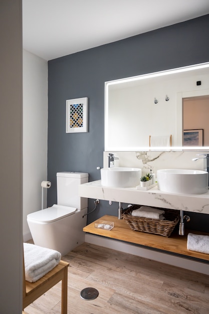 Interior of light modern bathroom with a mirror with light