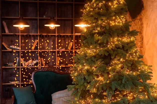 The interior of the living room in the Christmas style with a large fir-tree and Сhristmas gifts