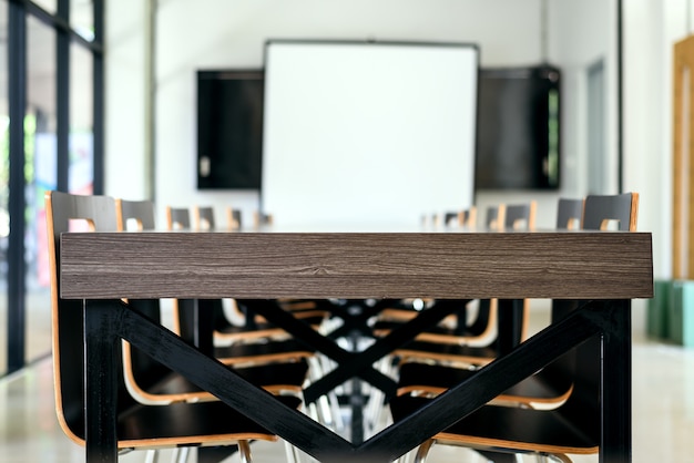 Interior of meeting room with wooden table and chairs in modern office