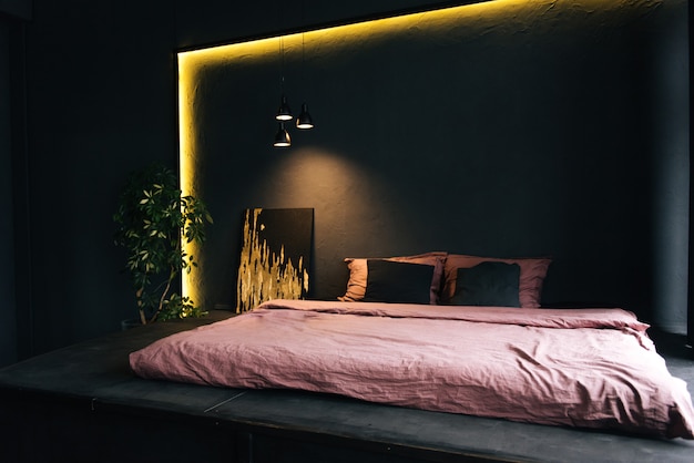 The interior of a modern apartment in black with yellow lighting. Beautiful interior decor