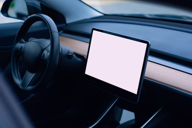 Interior of a modern car. Photo of a car interior with a mockup of a tablet with a white screen.