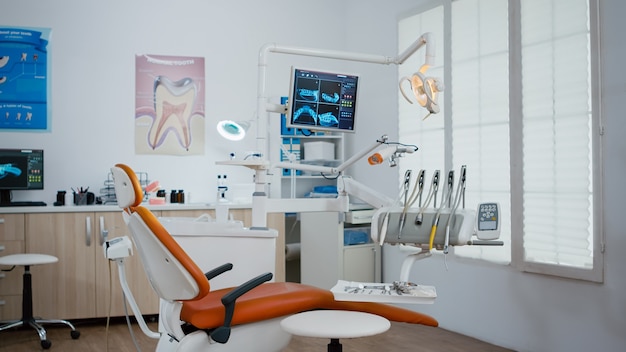 Interior of modern equipment oral office with teeth x ray on monitors