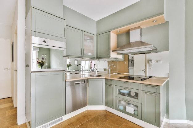 Interior of modern kitchen with green furniture