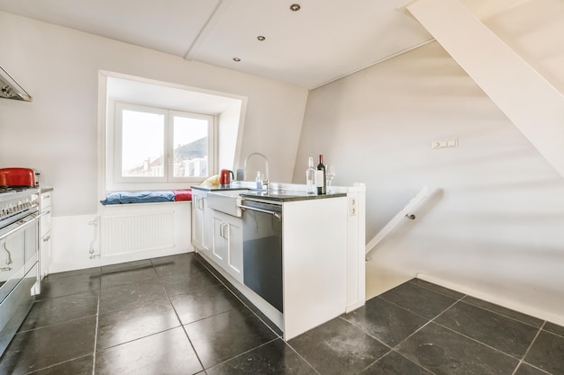 Interior of modern kitchen with white furniture