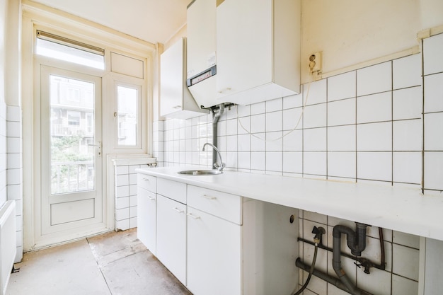 Interior of modern kitchen with white furniture