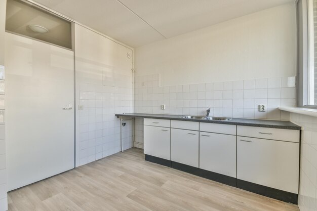 Interior of modern kitchen with white furniture