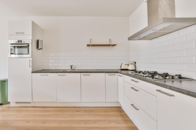 Interior of modern kitchen with white furniture