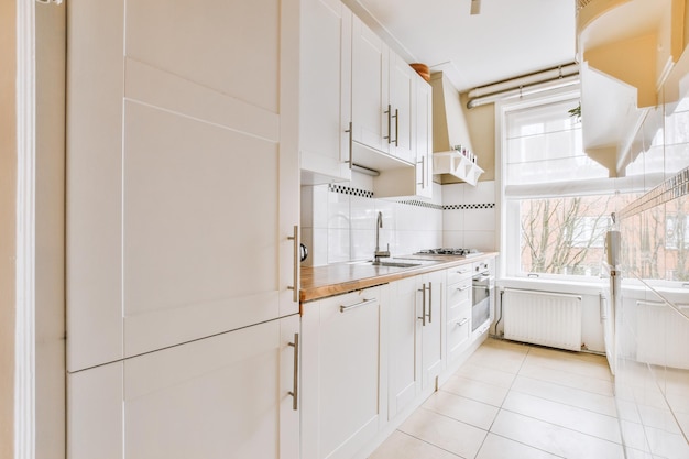 Interior of modern kitchen with white furniture