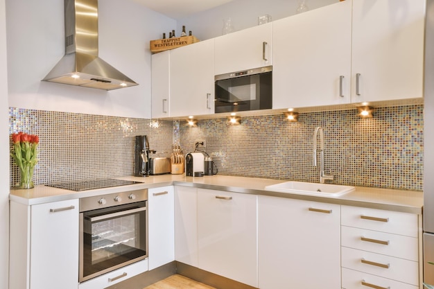 Interior of modern kitchen with white furniture