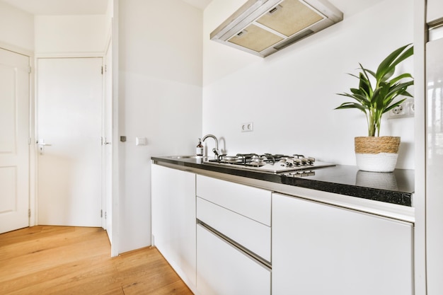 Interior of modern kitchen with white furniture