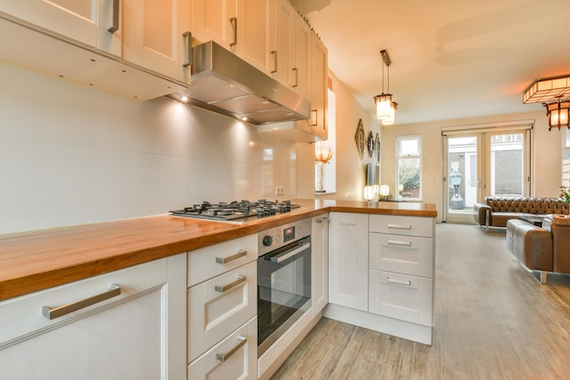 Interior of modern kitchen with white furniture