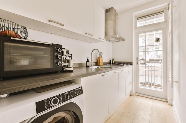 Interior of modern kitchen with white furniture