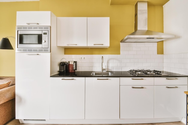 Interior of modern kitchen with white furniture