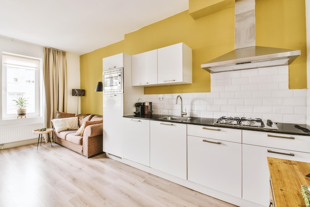 Interior of modern kitchen with white furniture