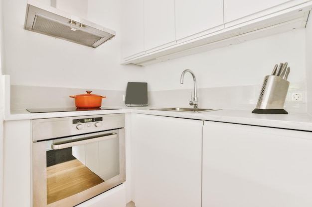 Interior of modern kitchen with white furniture