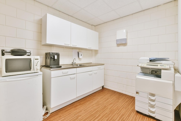 Interior of modern kitchen with white furniture