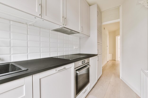 Interior of modern kitchen with white furniture