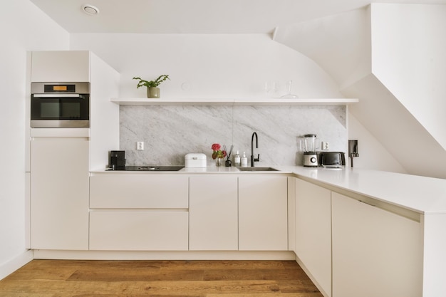 Interior of modern kitchen with white furniture