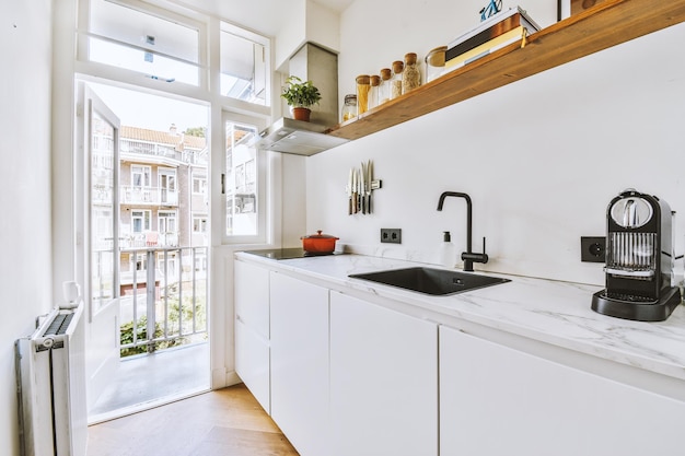 Interior of modern kitchen with white furniture