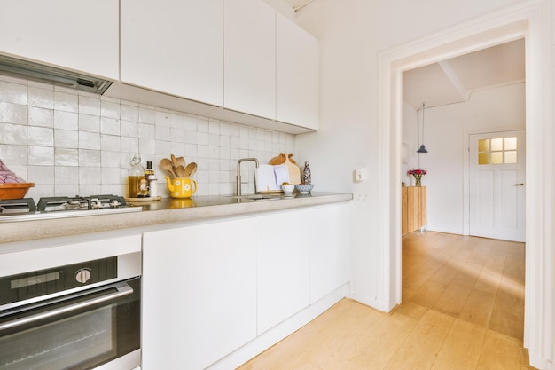 Interior of modern kitchen with white furniture